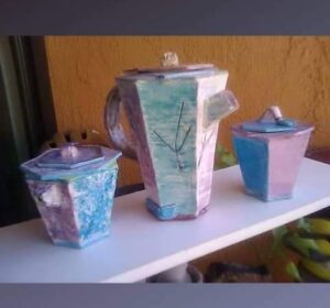 Tall tea pot with matching creamer and sugar containers